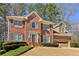 Charming two-story brick home with a well-manicured lawn and attached two car garage at 1150 Cedar Bluff Sw Trl, Lilburn, GA 30047
