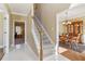 Open foyer with white tile flooring and a view of the staircase and dining room at 1150 Cedar Bluff Sw Trl, Lilburn, GA 30047