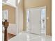Inviting foyer with white tile flooring, side windows, and a view of the staircase at 1150 Cedar Bluff Sw Trl, Lilburn, GA 30047