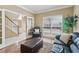 Bright living room with French doors, hardwood floors, a sofa, and a decorative chair at 1150 Cedar Bluff Sw Trl, Lilburn, GA 30047