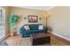 Comfortable living room with hardwood floors, a blue sofa, and natural light at 1150 Cedar Bluff Sw Trl, Lilburn, GA 30047
