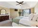 Beautiful main bedroom featuring a tray ceiling, fan, carpet, and large windows that enhance natural light at 1150 Cedar Bluff Sw Trl, Lilburn, GA 30047