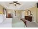 Lovely main bedroom featuring a tray ceiling, fan, carpet, and a decorative sitting area by the window at 1150 Cedar Bluff Sw Trl, Lilburn, GA 30047