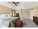 Inviting main bedroom with a tray ceiling, fan, carpet, and a sitting area to enjoy natural lighting at 1150 Cedar Bluff Sw Trl, Lilburn, GA 30047