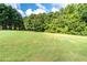 Expansive green lawn with lush trees at 260 Koller Dr, Powder Springs, GA 30127