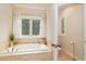 Bathroom with jetted tub, separate shower, and updated fixtures at 260 Koller Dr, Powder Springs, GA 30127