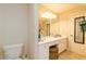 Bright bathroom with a vanity, toilet, and a large mirror at 260 Koller Dr, Powder Springs, GA 30127