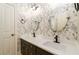 Elegant bathroom with double vanity, updated fixtures, and leaf patterned wallpaper at 260 Koller Dr, Powder Springs, GA 30127
