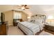 Main bedroom with king-size bed, ceiling fan, and relaxing armchair at 260 Koller Dr, Powder Springs, GA 30127