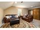 Comfortable bonus room with leather sofas, a large rug, and built-in shelving at 260 Koller Dr, Powder Springs, GA 30127