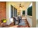 Relaxing front porch boasts brick floor and wicker seating at 260 Koller Dr, Powder Springs, GA 30127