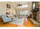 Spacious living room with stone fireplace, hardwood floors, and ample natural light at 260 Koller Dr, Powder Springs, GA 30127