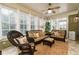 Relaxing sunroom boasts wicker furniture and abundant natural light at 260 Koller Dr, Powder Springs, GA 30127