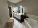 Bathroom with double vanity, large mirror and bathtub at 284 Valley Way, Hampton, GA 30228