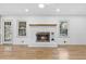 White brick fireplace with a wood mantel in the Gathering room at 3384 Hidden Acres Dr, Atlanta, GA 30340