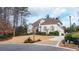 Charming home exterior featuring manicured landscaping, a circular driveway, and classic shuttered windows at 510 Newport Trce, Alpharetta, GA 30005