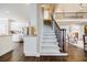 Staircase with wooden railing, hardwood floors, and views of the kitchen and living spaces at 510 Newport Trce, Alpharetta, GA 30005