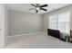 Neutral bedroom features a ceiling fan, large window and mounted television at 6860 Crofton Dr, Alpharetta, GA 30005