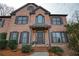 Charming brick home with meticulously landscaped front yard and covered front porch at 6860 Crofton Dr, Alpharetta, GA 30005