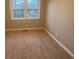 Simple bedroom with neutral-colored carpet and new paint at 1790 Spring Ave, East Point, GA 30344