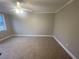 Spacious carpeted bedroom with ceiling fan and neutral walls at 1790 Spring Ave, East Point, GA 30344