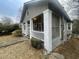 View of the charming bungalow showing the front porch, siding, and landscaping at 1790 Spring Ave, East Point, GA 30344