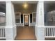 Inviting front porch with white columns, dark trim, and a cozy, covered space to relax at 1790 Spring Ave, East Point, GA 30344