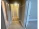 Hallway with neutral paint, tile flooring, multiple doors and easy access to rooms at 1790 Spring Ave, East Point, GA 30344