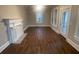 Bright and spacious living room with a fireplace, hardwood floors, and access to the porch through the glass door at 1790 Spring Ave, East Point, GA 30344