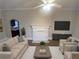 Open-concept living room with a fireplace, modern furniture, and plenty of natural light at 1790 Spring Ave, East Point, GA 30344
