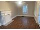 Cozy living room showcasing the new floors, fireplace, neutral color palette, and modern ceiling fan at 1790 Spring Ave, East Point, GA 30344