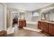 Bathroom includes double sinks, a soaking tub, glass shower and hardwood floors at 6615 Hampton Rock Ln, Cumming, GA 30041