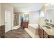 Bathroom includes double sinks, a soaking tub, glass shower and hardwood floors at 6615 Hampton Rock Ln, Cumming, GA 30041