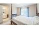 This bedroom features a four post bed and a partially opened door to an on-suite bathroom at 6615 Hampton Rock Ln, Cumming, GA 30041