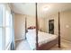 This bedroom features a four post bed and a view of the closet at 6615 Hampton Rock Ln, Cumming, GA 30041