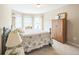 Bedroom with bay window, floral bedding, wood floors and plenty of natural light at 6615 Hampton Rock Ln, Cumming, GA 30041