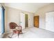 Bedroom with vaulted ceilings, rocking chair, closet and armoire at 6615 Hampton Rock Ln, Cumming, GA 30041