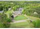 An aerial view of the community clubhouse, featuring a manicured lawn and surrounding trees at 6615 Hampton Rock Ln, Cumming, GA 30041