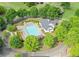 Aerial view of the community pool area, featuring a large pool, seating, and landscaped grounds at 6615 Hampton Rock Ln, Cumming, GA 30041