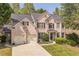 Charming brick home with a well-manicured lawn and two-car garage at 6615 Hampton Rock Ln, Cumming, GA 30041