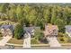 Beautiful two-story homes with well-manicured lawns and long driveways surrounded by lush trees at 6615 Hampton Rock Ln, Cumming, GA 30041