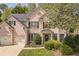 Charming two-story brick home with well-manicured lawn and a two-car garage provides an inviting curb appeal at 6615 Hampton Rock Ln, Cumming, GA 30041