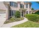 Inviting walkway leads to the front door of this beautiful brick home, complemented by lush landscaping and mature trees at 6615 Hampton Rock Ln, Cumming, GA 30041