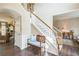 Spacious foyer with hardwood floors, staircase, and bench seating; entry to living area with nice natural light at 6615 Hampton Rock Ln, Cumming, GA 30041