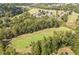 An aerial view of the well-maintained golf course winding through the lush landscape of the community at 6615 Hampton Rock Ln, Cumming, GA 30041