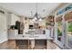 Eat-in kitchen boasts modern appliances, island, white cabinets, and access to outdoor patio, great for entertaining at 6615 Hampton Rock Ln, Cumming, GA 30041