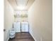 This Laundry Room features a washer, a dryer and a shelf at 6615 Hampton Rock Ln, Cumming, GA 30041