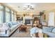 Inviting living room with fireplace, large windows, hardwood floors, and comfortable seating, ideal for relaxation at 6615 Hampton Rock Ln, Cumming, GA 30041