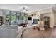 Bright and airy living room with hardwood floors, fireplace, and comfortable seating with lots of natural light at 6615 Hampton Rock Ln, Cumming, GA 30041