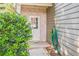 A convenient side entrance is surrounded by greenery and a durable brick facade at 6615 Hampton Rock Ln, Cumming, GA 30041